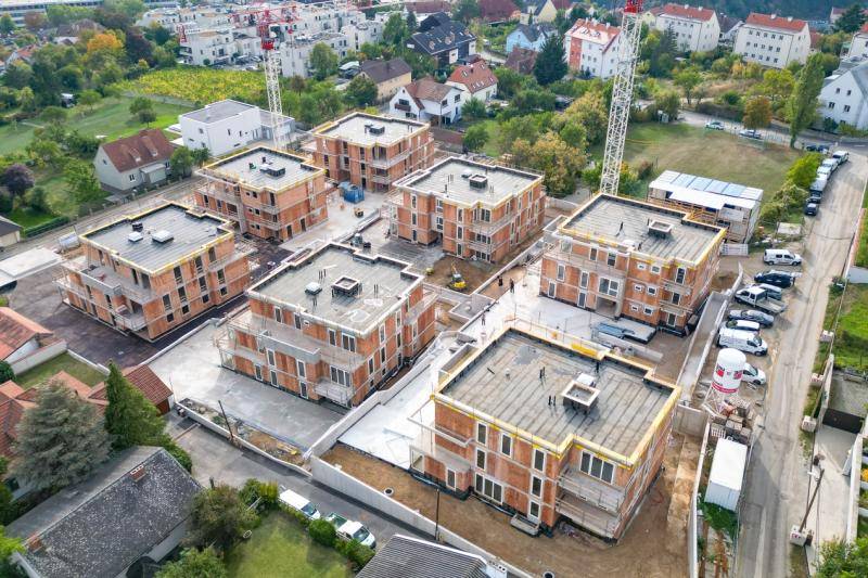 Luftaufnahme des aktuellen Bauvorschritts. Die 7 Gebäude sind im Bau. Fenster sind fertig eingebaut, sowie die Dächer abgedichtet. Luftaufnahme des aktuellen Bauvorschritts. Die 7 Gebäude sind im Bau. Fenster sind fertig eingebaut, sowie die Dächer abgedichtet.
